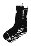 Black anti-slip grip socks by TRINITY, featuring a sleek design with dotted grip patterns for enhanced stability and comfort, perfect for various sports like running, football, padel, and gym workouts.