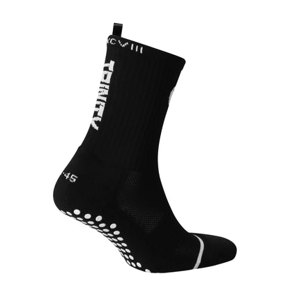 Black anti-slip grip socks by TRINITY, featuring a sleek design with dotted grip patterns for enhanced stability and comfort, perfect for various sports like running, football, padel, pilates and gym workouts.