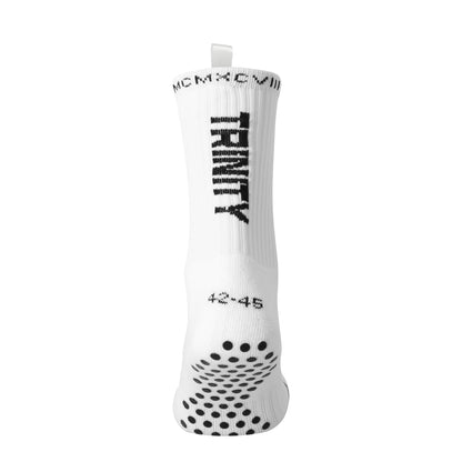 White anti-slip grip socks by TRINITY, featuring a sleek design with dotted grip patterns for enhanced stability and comfort, perfect for various sports like running, football, padel, pilates and gym workouts.