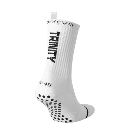 White anti-slip grip socks by TRINITY, featuring a sleek design with dotted grip patterns for enhanced stability and comfort, perfect for various sports like running, football, padel, pilates and gym workouts.