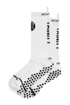 White anti-slip grip socks by TRINITY, featuring a sleek design with dotted grip patterns for enhanced stability and comfort, perfect for various sports like running, football, padel, pilates and gym workouts.